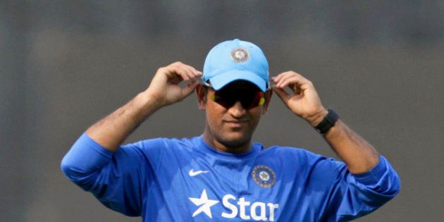 India's captain MS Dhoni adjusts his cap as he attends a practice session ahead of the fifth one day international cricket match against South Africa in Mumbai, India, Saturday, Oct. 24, 2015. (AP Photo/Rajanish Kakade)