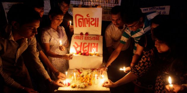 Indians place candles as they remember last yearâs gang rape and murder of a young woman in New Delhi, in Ahmadabad, India, Saturday, Dec. 14, 2013. The victim, a 23-year-old physiotherapy student, was heading home with a male friend after an evening showing of the movie