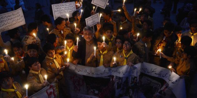 LAHORE, PUNJAB, PAKISTAN - 2015/12/15: Pakistani students,teachers and civil society activists hold lit candles during a vigil to pay tribute to the victims of the Peshawar school massacre of December 16, 2014, the deadliest terror attack in Pakistan's history. (Photo by Rana Sajid Hussain/Pacific Press/LightRocket via Getty Images)