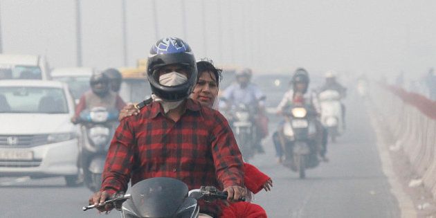NEW DELHI, INDIA - NOVEMBER 13: Commuters drive past as roads were seen covered in smog, on November 13, 2015 in New Delhi, India. Pollution soared to hazardous levels in Delhi on the night of Diwali, reaching 40 times the limit recommended by the World Health Organisation. Air pollution is also a leading cause of premature death in India, with about 620,000 people dying every year from pollution-related diseases. Experts say these particulate matters which are way above the permissible limit are extremely dangerous for people suffering from asthma and other respiratory and cardiac problems, and also for children and the elderly. (Photo by Raj K Raj/Hindustan Times via Getty Images)