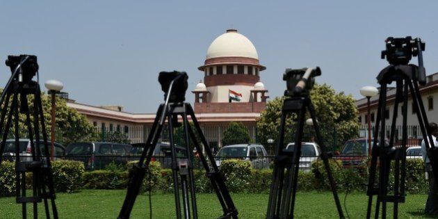 Camera tripods are lined up outside the Supreme court during the judgement on 'Santhara' in New Delhi on August 31, 2015. India's Jain community scored a legal victory when the Supreme Court temporarily lifted a ban on the traditional ritual of Santhara, or fasting to death. AFP PHOTO / MONEY SHARMA (Photo credit should read MONEY SHARMA/AFP/Getty Images)