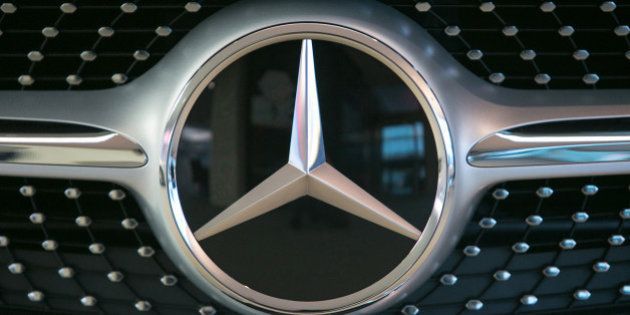 The Mercedes-Benz logo sits on a S-Class automobile in the center of excellence showroom at Daimler AG's Mercedes-Benz factory in Sindelfingen, Germany, on Monday, Nov. 23, 2015. Daimler's Mercedes-Benz brand is poised to overtake Volkswagen AG's Audi this year as the world's second-largest maker of luxury cars, driven by a revamped lineup of sport-utility vehicles and the flagship S-Class sedan. Photographer: Krisztian Bocsi/Bloomberg via Getty Images