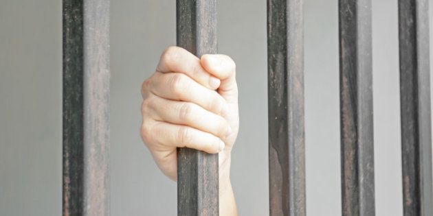 Hands of a woman in jail