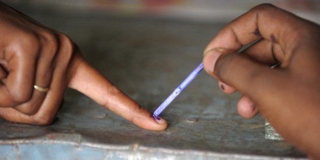 An Indian polling officer marks the finger of a voter with ink at a polling station at Rangareddy on the outskirts of Hyderabad on April 30, 2014. India's 814-million-strong electorate is voting in the world's biggest election which is set to sweep the Hindu nationalist opposition to power at a time of low growth, anger about corruption and warnings about religious unrest. AFP PHOTO / Noah SEELAM (Photo credit should read NOAH SEELAM/AFP/Getty Images)