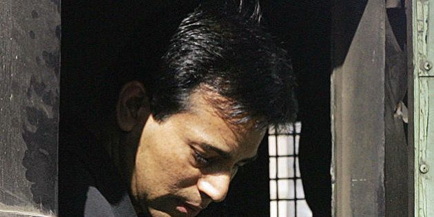 MUMBAI, INDIA: Alledged Indian gangster Abu Salem looks out from a police van before entering a special court in Mumbai, 23 November 2005. Salem, alleged to be one of the masterminds of the 1993 serial bombings in the city, has been remanded to judicial custody for 10 days. Salem and his girlfriend Bollywood actress Monica Bedi were extradited to India earlier this month from Portugal . AFP PHOTO/Sebastian D'SOUZA. (Photo credit should read SEBASTIAN D'SOUZA/AFP/Getty Images)