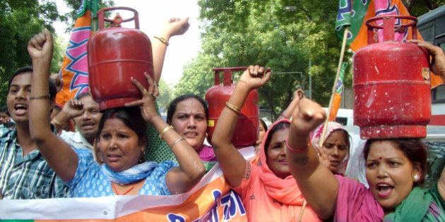 NEW DELHI, INDIA - OCTOBER 12: BJP Mahila Morcha activists carry LPG cylinders during a protest against the recent hike in prices of cooking gas, electricity and diesel at Jantar Mantar in New Delhi on Friday. (Photo by Ramesh Sharma/India Today Group/Getty Images)