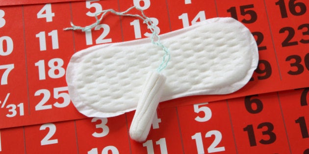 The sanitary napkin lying on a red calendar.