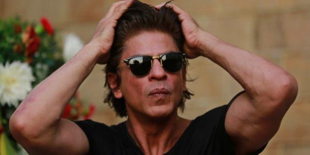 Bollywood superstar Shahrukh Khan adjusts his hair as he listens to a question from a journalist on his birthday in Mumbai, India, Sunday, Nov. 2, 2014. (AP Photo/Rafiq Maqbool)