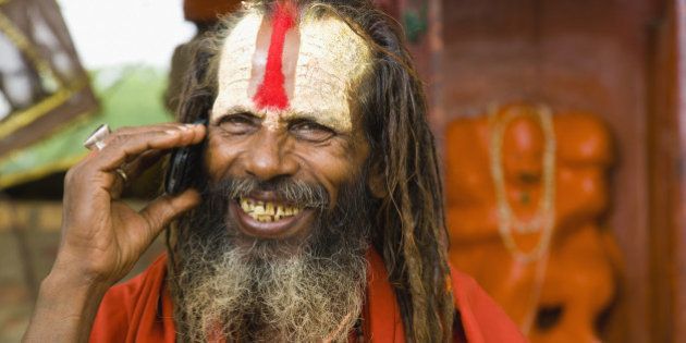 Sadhu man with mobile phone