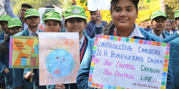 NEW DELHI, INDIA - DECEMBER 30: School children took out a rally in support of the odd-even formula introduced by the Delhi Government for controlling pollution on December 30, 2015 in Janakpuri in New Delhi, India. The odd-even formula will be enforced from January 1, 2016 for a trial period of 15 days. (Photo by S Burmaula/Hindustan Times via Getty Images)