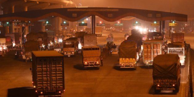 In this photograph taken late November 14, 2015, shows a general view of trucks entering New Delhi at Badarpur Toll Plaza, at Faridabad, India. AFP PHOTO / Money SHARMA / AFP / MONEY SHARMA (Photo credit should read MONEY SHARMA/AFP/Getty Images)