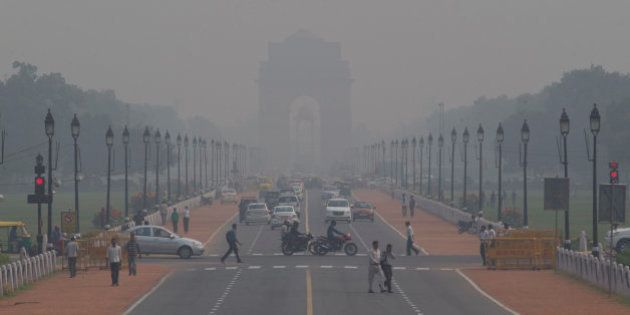 India Gate, one of the landmarks of central Delhi, is barely visible through thick smog in New Delhi, India, Monday, Nov. 9, 2015. Delhi's air quality has been hitting new lows over the past week and authorities are urging people to refrain from lighting smoke emanating firecrackers during the upcoming Diwali festival. (AP Photo/Saurabh Das)