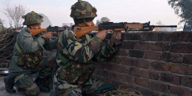 Indian army soldiers take up position on the perimeter of an airforce base in Pathankot on January 3, 2016, during an operation to 'sanitise' the base following an attack by gunmen. The deadly assault on an Indian air base near the Pakistan border was 'a heinous' terrorist attack, the United States said, urging the two rivals to work together to hunt down those responsible. Three security officers were killed in the attack by suspected Islamist militants on Pathankot base in northern Punjab state early January 2. At least four attackers also died in shootouts with security forces. AFP PHOTO/NARINDER NANU / AFP / NARINDER NANU (Photo credit should read NARINDER NANU/AFP/Getty Images)