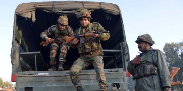 Indian army personnel leap from the rear of a truck at an airforce base in Pathankot on January 3, 2016, during an operation to 'sanitise' the base following an attack by gunmen. The deadly assault on an Indian air base near the Pakistan border was 'a heinous' terrorist attack, the United States said, urging the two rivals to work together to hunt down those responsible. Three security officers were killed in the attack by suspected Islamist militants on Pathankot base in northern Punjab state early January 2. At least four attackers also died in shootouts with security forces. AFP PHOTO/NARINDER NANU / AFP / NARINDER NANU (Photo credit should read NARINDER NANU/AFP/Getty Images)