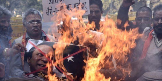 NEW DELHI, INDIA - JANUARY 2: Members of Hindu Sena, burn an effigy of Pakistani Prime Minister Nawaz Sharif to protest against a militant attack at the Pathankot Air Base, on January 2, 2016, in New Delhi, India. Suspected Islamist gunmen have staged a pre-dawn attack on a key Indian Air Base near the Pakistan border with two militants killed in a shootout, officials said, striking a blow to the neighbours' fragile peace process at Pathankot. Four terrorists and three Indian Air Force (IAF) personnel were killed in an attack on an Air Force Base in Punjabâs Pathankot district early on Saturday morning, setting alarm bells ringing across the country. (Photo by Arun Sharma/Hindustan Times via Getty Images)