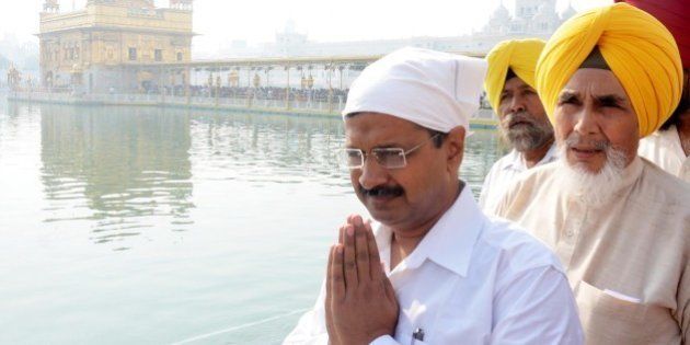 AMRITSAR, INDIA - OCTOBER 24: Delhi Chief Minister Arvind Kejriwal and AAP Punjab convener from Chhotepur, Sucha Singh paying obeisance at Golden Temple on October 24, 2015 in Amritsar, India. Kejriwal said that it was the responsibility of Punjab government to arrest the real culprits behind the incidents of desecration of holy books, adding no innocent person should be slapped with false cases. (Photo by Sameer Sehgal/Hindustan Times via Getty Images)