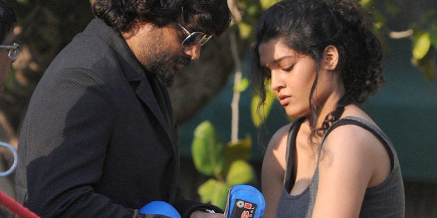 Indian Bollywood actors Ritika Singh (R) and R. Madhavan pose during the promotion of upcoming Hindi film 'Saala Khadoos' directed by Sudha Kongara in Mumbai on January 11, 2016. AFP PHOTO / AFP / STR (Photo credit should read STR/AFP/Getty Images)