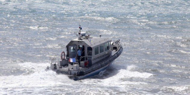 French maritime gendarmes in a boat take part in the search for wreckage from the missing MH370 plane off of Saint-Marie on the French island of La Reunion on August 14, 2015. France will conduct air and sea searches off its Indian Ocean territory of Reunion until the start of next week for debris from missing flight MH370, the island's top official said on August 12. AFP PHOTO / RICHARD BOUHET (Photo credit should read RICHARD BOUHET/AFP/Getty Images)