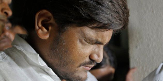 Hardik Patel, a popular leader of Patidars, a farming caste group, gestures as he speaks with media at his lawyerâs office in Ahmadabad, India, Wednesday, Sept. 23, 2015.The Patidars, also known as the Patel community for the last name they share, are demanding the same special status given to many minorities in India, guaranteeing them a share of government jobs and school placements. (AP Photo/Ajit Solanki)