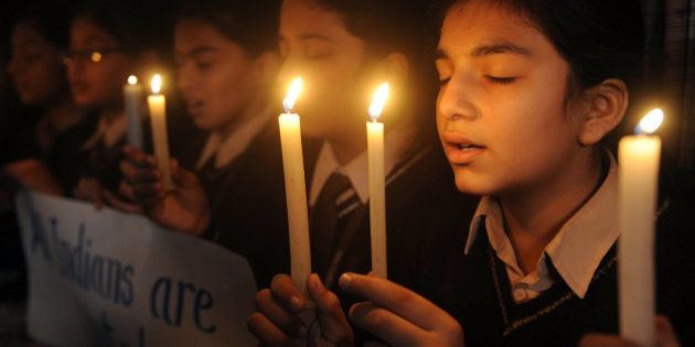 Indian school girls hold candles at DAV Public school in Amritsar on November 26, 2010 in tribute to those killed in the 26/11 Mumbai attacks. India marked today the second anniversary of the militant attacks on Mumbai with memorial events and prayer meetings to honour the 166 victims killed during 60 hours of carnage. AFP PHOTO/NARINDER NANU (Photo credit should read NARINDER NANU/AFP/Getty Images)