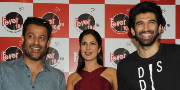 Indian Bollywood actors Katrina Kaif (C) and Aditya Roy Kapur (R) pose for a photograph during a promtional event for the forthcoming Hindi film 'Fitoor' directed by Abhishek Kapoor (L) in Mumbai on January 8, 2016. AFP PHOTO / STR / AFP / STRDEL (Photo credit should read STRDEL/AFP/Getty Images)