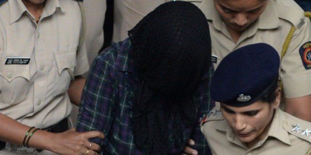Indian police escort former media executive Indrani Mukherjea (C) from a city court in Mumbai on August 31, 2015. A former Indian media executive has been arrested on suspicion of murdering her daughter for having an affair with her stepson, Mumbai police said August 28, in a case gripping India. Indrani Mukerjea is accused, along with two others, of strangling Sheena Bora to death in 2012 before dumping her body in a forest in western Maharashtra state and setting it alight. AFP PHOTO / INDRANIL MUKHERJEE (Photo credit should read INDRANIL MUKHERJEE/AFP/Getty Images)