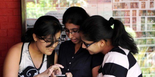 NEW DELHI, INDIA - MAY 30: Students checking their CBSE class 10 examination result on mobile on May 30, 2013 in New Delhi, India. Girls fared better than boys 98.94 percent of girls passed their examinations as compared to 98.64 percent of boys. (Photo by Sushil Kumar/Hindustan Times via Getty Images)