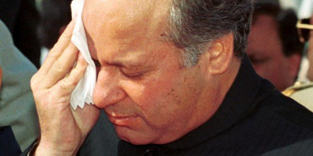 FILE-Nawaz Sharif, deposed prime minister of Pakistan, wipes his face in this August 14, 1999 file photo. A special anti-terrorist court will hear charges of treason and kidnapping or hijacking against Sharif and seven others. If convicted they could be sentenced to life in prison or death. The charges were filed with police in the southern port city of Karachi on Thursday, Nov. 11, 1999. (AP Photo/Mian Khursheed)