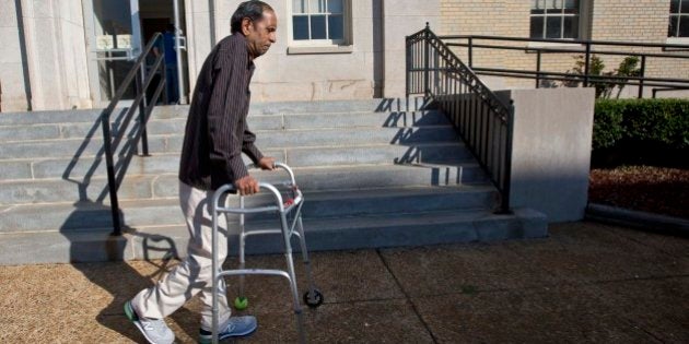 Sureshbhai Patel steadies himself with a walker as he arrives at the federal courthouse before start of a trial against Madison, Ala., police officer Eric Sloan Parker, Tuesday, Sept. 1, 2015, in Huntsville, Ala. Patel, who was visiting relatives from his native India in February, was walking in his son's neighborhood when police responding to a call about a suspicious person stopped to question him. A police video captured an officer slamming the man to the ground, partially paralyzing him. (AP Photo/Brynn Anderson)