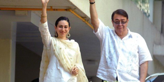 'MUMBAI, INDIA - OCTOBER 16: Randhir Kapoor and Karisma Kapoor appear on the balcony after the Saif-Kareena's registry marriage at Fortune Heights, Saif's residence in Bandra on October 16, 2012 in Mumbai, India. (Photo by Prodip Guha/Hindustan Times via Getty Images)'