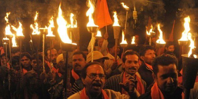 Indian activists of the Hindu Bajrang Dal Party hold torches during a procession marking the 22nd anniversary of the demolition of the Babri Masjid Mosque in Ayodhya, in Amritsar on December 6, 2014. Hindu hardliners demolished the Babri Mosque on December 6, 1992, claiming it was built on the site of the birth place of the Hindu God Ram, sparking off country wide Hindu-Muslim riots. AFP PHOTO / NARINDER NANU (Photo credit should read NARINDER NANU/AFP/Getty Images)