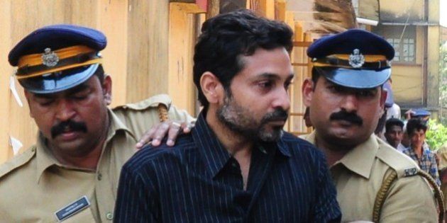 Indian police personnel escort murder suspect Muhammad Nisham (C), accused of fatally wounding a security guard by driving into him with his car, at the Judicial Magistrate's Court in Thrissur on March 11, 2015. Beedi tycoon Mohammed Nisham, accused of killing a security guard by driving into him with his SUV, was held March 9 under the state of Karala's Anti-Social Activities Act, under which he will be denied bail for at least six months. AFP PHOTO / STR (Photo credit should read STRDEL/AFP/Getty Images)
