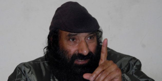 Syed Salahuddin, head of Kashmiri militant group Hizb-ul-Mujahedin, gestures during a press conference in Muzaffarabad on March 24, 2013. Salahuddin, accused Pakistan's former military ruler Pervez Musharraf of betrayal for signing a ceasefire deal with India in the divided Himalayan region during his rule. AFP PHOTO/Sajjad QAYYUM (Photo credit should read SAJJAD QAYYUM/AFP/Getty Images)