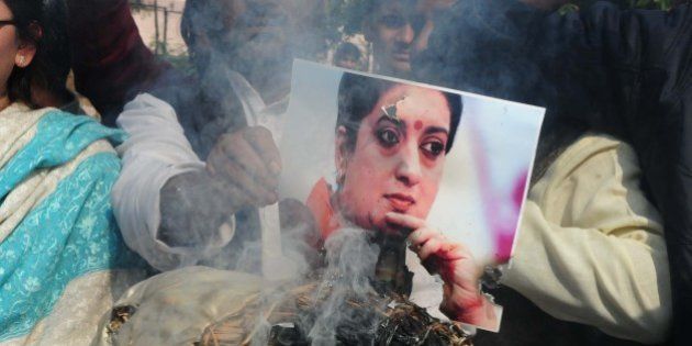 BHOPAL, INDIA - JANUARY 20: Congress workers burning an effigy of union HRD Minister Smriti Irani while protesting over the death of Rohith Vemula, a doctorate student at the Hyderabad Central University who was found hanging in the campus hostel room, on January 20, 2016 in Bhopal, India. 26-year-old Vemula committed suicide on Sunday night. He was among the five research scholars who were suspended by the Hyderabad Central University in August last year over an alleged assault case. They were also kept out of the hostel. The five were allegedly suspended after BJP leader Bandaru Dattatreya wrote a letter to HRD Minister Smriti Irani, describing the university as a 'den of casteist, extremist and anti-national politics'. (Photo by Arijit Sen/Hindustan Times via Getty Images)