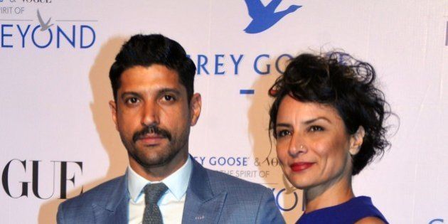Indian Bollywood actor Farhan Akhtar (L) poses with his wife actress Adhuna Akhtar during the Grey Goose Fly Beyond Awards ceremony in Mumbai late November 16, 2014. AFP PHOTO/STR (Photo credit should read STRDEL/AFP/Getty Images)