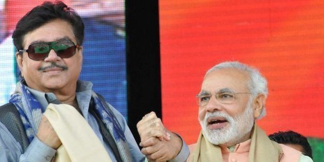 PATNA, INDIA - OCTOBER 27: Gujarat CM and BJP's prime ministerial candidate Narendra Modi with Shatrughan Sinha, former Bollywood actor and politician at the Hunkar rally on October 27, 2013 in Patna, India. The rally was preceded by a series of low-intensity blasts in the Bihar capital. One man was killed and five people were wounded in the blasts that occurred shortly before Modi arrived in Patna to launch the campaign. (Photo by AP Dube/Hindustan Times via Getty Images)