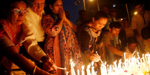 Indians light candles as they pay tribute to Indian soldiers killed in the Pathankot air base attack, in Mumbai, India, Wednesday, Jan 6, 2016. Indian forces have killed the last of the six militants who attacked an air force base near the Pakistan border over the weekend, the defense minister said Tuesday, though soldiers were still searching the base as a precaution.(AP Photo/Rajanish Kakade)
