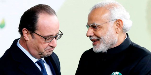 French President Francois Hollande, left, greets India's Prime Minister Narendra Modi as he arrives for the COP21, United Nations Climate Change Conference, in Le Bourget, outside Paris, Monday, Nov. 30, 2015. (Guillaume Horcajuelo, Pool via AP)