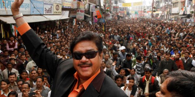 Bharatiya Janata Party leader and Bollywood actor Shatrughan Sinha, waves to the crowd as he attends an election campaign rally in Allahabad, India, Monday, Feb. 13, 2012. India's largest state Uttar Pradesh is currently going to the polls in seven-phases in a month long local election with repercussions for the whole nation. (AP Photo/Rajesh Kumar Singh)