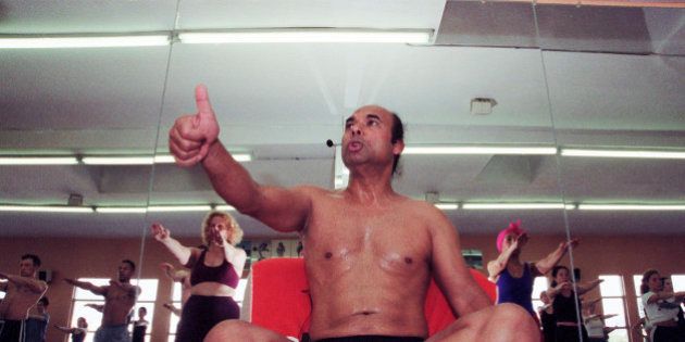 Low-angle view of Indian Yoga guru Bikram Choudhury as he instructs his yoga class in heated room, Beverly Hills, California, February 2, 2000. (Photo by Bob Riha, Jr./Getty Images)