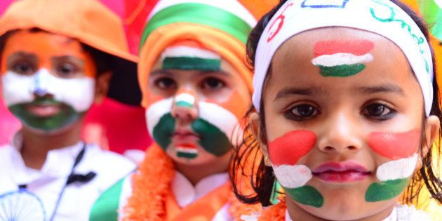 RAJASTHAN, INDIA - 2016/01/25: Indian first step school children paint the tricolor of Indian flag on their face and raise the National Flag on the eve of republic day celebrations in Rajasthan, India. (Photo by Shaukat Ahmed/Pacific Press/LightRocket via Getty Images)