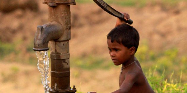 A young Indian boy pumps water from a tube well and stretches to fill a bottle with water, on the outskirts of Bhubaneshwar, India, Saturday, May 12, 2012. According to U.N. estimates, more than one in six people worldwide do not have access to 20-50 liters (5-13 gallons) of safe freshwater a day to ensure their basic needs for drinking, cooking and cleaning. (AP Photo/Biswaranjan Rout)