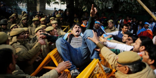 A member of the National Students Union of India (NSUI), the student wing of India's main opposition Congress party, shouts slogans as he got entangled in police barricade during a protest against the death of Rohith Vemula in New Delhi, India, Friday, Jan. 22, 2016. The students were protesting the death of Vemula who, along with four others, was barred from using some facilities at his university in the southern tech-hub of Hyderabad. The protesters accused Hyderabad University's vice chancellor and a federal minister of unfairly demanding punishment for the five lower-caste students after they clashed last year with a group of students supporting the governing Hindu nationalist party. (AP Photo/Altaf Qadri)