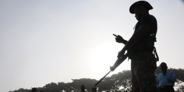 BASTAR, INDIA - NOVEMBER 11: Paramilitary police guards a polling booth during the first phase of assembly elections of Chhattisgarh at Jagadalpur on November 11, 2013 in Bastar, India. The Election Commission in Delhi said that 67 per cent turnout was witnessed in the first phase of Assembly polls in eight Naxal-hit districts in Chhattisgarh. A total of fourteen encounters between security forces and Naxalite groups took place today in which a CRPF personnel was killed. (Photo by Parwaz Khan/Hindustan Times via Getty Images)