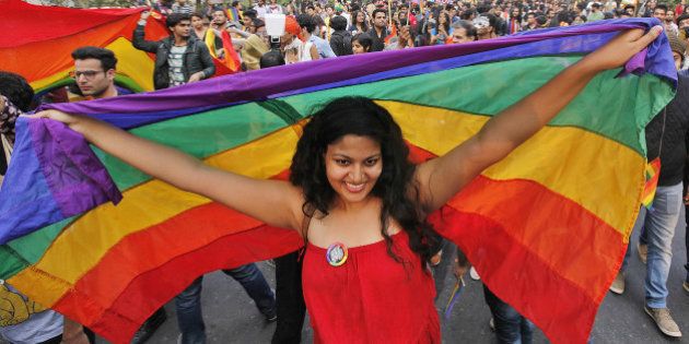 NEW DELHI, INDIA - NOVEMBER 29: A LGBT rights activist holds rainbow flag during Delhi Queer Pride March from Barakhamba Road to Jantar Mantar on November 29, 2015 in New Delhi, India. Organizers said that while the gay pride parade celebrated the gains India's LGBT community has made in recent years, they also wanted to highlight the continuing discrimination it faces. The Delhi Queer Pride Committee also demanded the repeal of Section 377 of the Indian Penal Code, which criminalizes homosexual acts. (Photo by Raj K Raj/Hindustan Times via Getty Images)