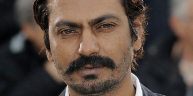 Actor Nawazuddin Siddiqui poses for photographers during a photo call for the film Monsoon Shootout at the 66th international film festival, in Cannes, southern France, Saturday, May 18, 2013. (AP Photo/Francois Mori)