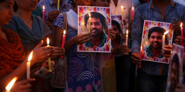 Activist of a Dalit organization participate in a candle light vigil holding photographs of Indian student Rohith Vemula in Hyderabad, India, Wednesday, Jan 20, 2016. The activists were protesting the death of Vemula who, along with four others, was barred from using some facilities at his university in the southern tech-hub of Hyderabad. The protesters accused Hyderabad University's vice chancellor and a federal minister of unfairly demanding punishment for the five lower-caste students after they clashed last year with a group of students supporting the governing Hindu nationalist party. (AP Photo/Mahesh Kumar A.)