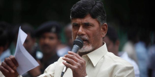 Telugu Desam Party (TDP) President N. Chandrababu Naidu speaks during a protest against the Babli Dam project in front of a statue of Mahatma Gandhi in Hyderabad, India, Wednesday, July 21, 2010. The protestors alleged that Maharashtra state is building the dam across River Godavari illegally and this would deprive Andhra Pradesh state of its due share of Godavari waters. Naidu was earlier arrested while trying to visit the project site and was forced to return to Hyderabad on Tuesday. (AP Photo/Mahesh Kumar A.)
