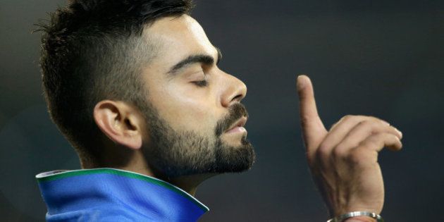 MELBOURNE, AUSTRALIA - JANUARY 29: Virat Kohli of India gestures to Australian fans to be quiet after India took the wicket of Glenn Maxwell of Australia during the International Twenty20 match between Australia and India at Melbourne Cricket Ground on January 29, 2016 in Melbourne, Australia. (Photo by Darrian Traynor - CA/Cricket Australia/Getty Images)