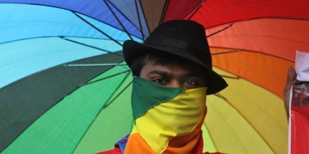 A participant holds an umbrella with rainbow colors as members of the Lesbian, Gay, Bisexual, Transgender (LGBT) community and their supporters from across India participate in a pride walk in Surat in Gujarat state, India, Sunday, Oct. 6, 2013. The walk was organized for the first time in the Gujarat state demanding social acceptance and equal rights. (AP Photo/Ajit Solanki)